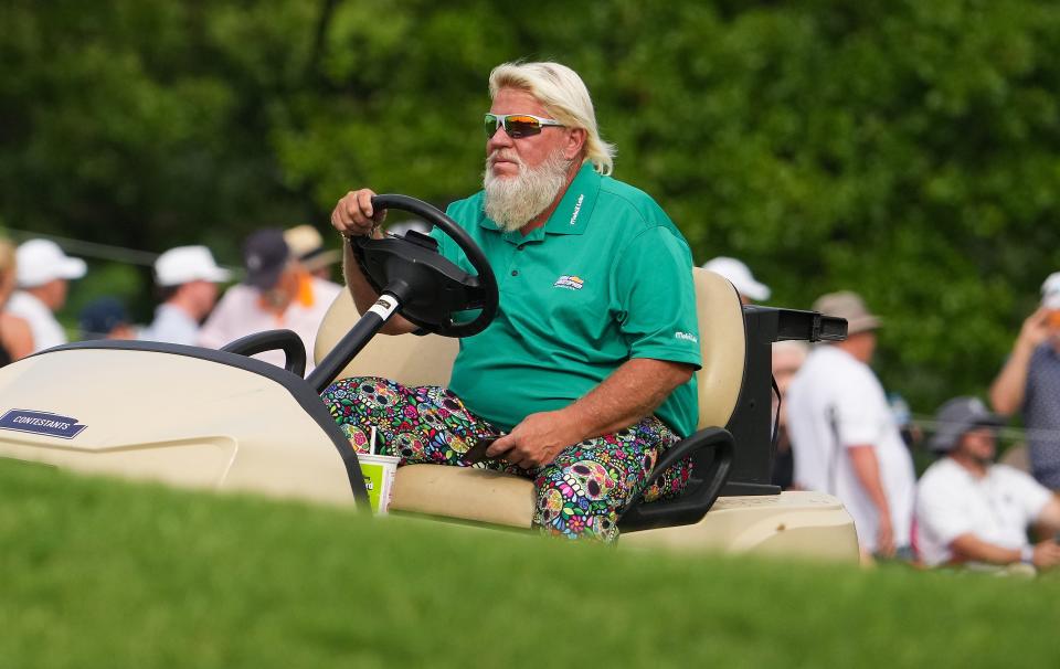 John Daly drives his golf cart during the first round of the PGA Championship.