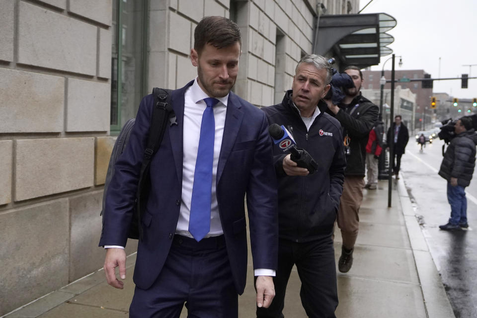 Scott Lauer, left, an attorney for Han Lee, walks past members of the media as he departs federal court, Wednesday, Nov. 22, 2023, in Worcester, Mass. Two people, Han Lee and Junmyung Lee, accused of operating a high-end brothel network with wealthy and prominent clients in Massachusetts and the Washington, D.C. suburbs, will remain behind bars for now, a judge said on Wednesday. (AP Photo/Steven Senne)