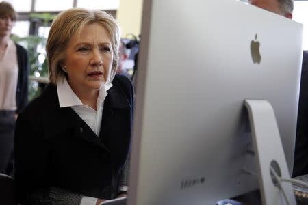 U.S. Democratic presidential candidate Hillary Clinton looks at a computer screen during a campaign stop at Atomic Object company in Grand Rapids, Michigan, U.S. March 7, 2016. REUTERS/Carlos Barria/File Photo