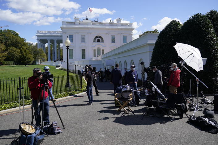 Members of the media gather outside the White House, Friday, Oct. 2, 2020, in Washington. (AP Photo/Alex Brandon)