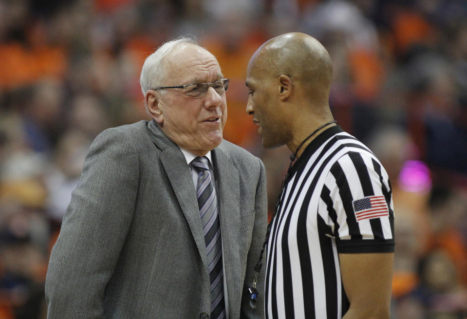 Syracuse head coach Jim Boeheim, left, talks to an official about a call during the second half of an NCAA college basketball game against Louisville in Syracuse, N.Y., Wednesday, Feb. 20, 2019. Syracuse won 69-49. (AP Photo/Nick Lisi)