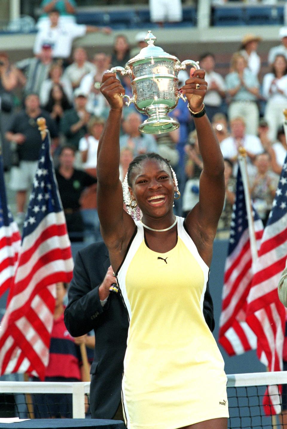 Serena Williams smiles and poses with her trophy after winning the US Open at the USTA National Tennis Courts in Flushing Meadows, New York on September 11, 1999.