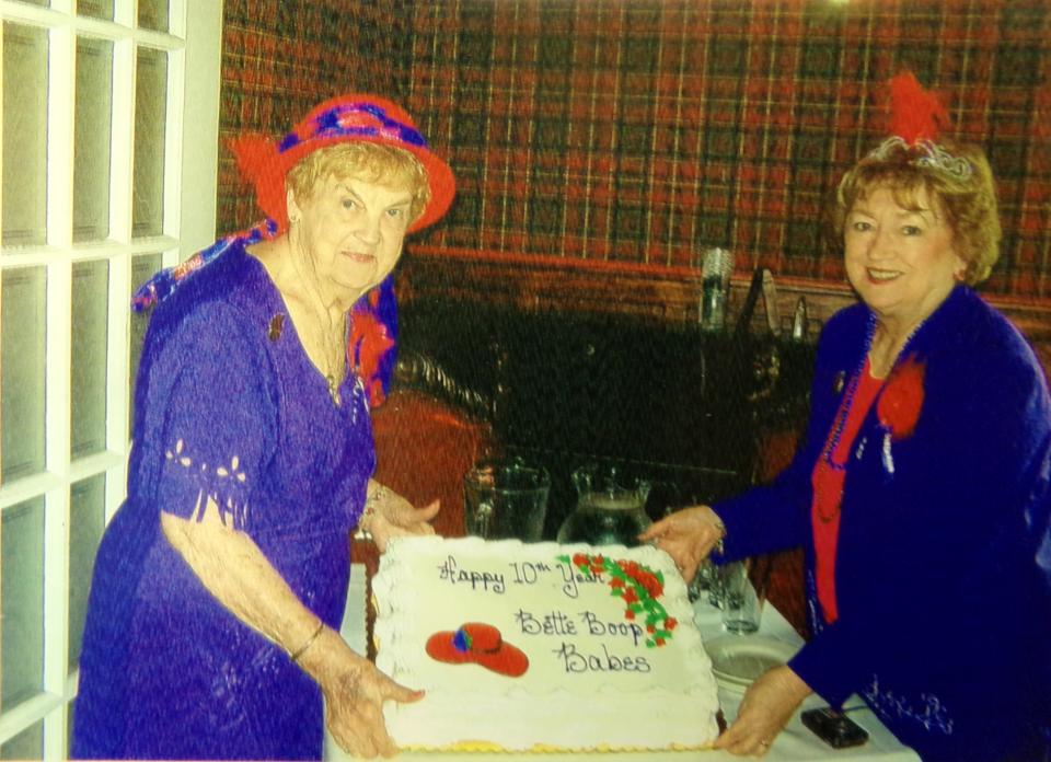 Former Queen Mother Bette Johnston and current Queen Mother Dee Cullen mark the 10th anniversary of the Red Hat Bette Boop Babes in July 2014 at a luncheon at Hotel Belvidere in Hawley. The chapter was named for the cartoon Betty Boop and for Bette Johnston, who Cullen said has eyes to match. Bette moved to Florida in 2013.