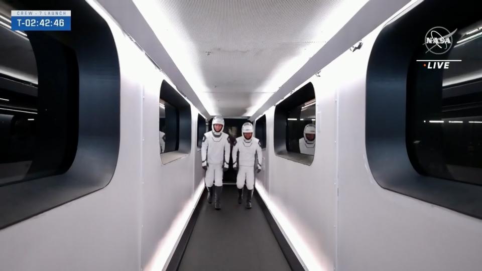 astronauts prepare to enter their spacecraft from the launch tower crew access arm.