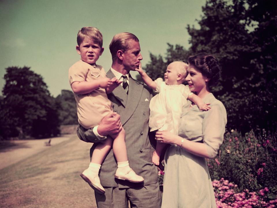 Prince Charles and Queen Elizabeth hold Prince Charles and Princess Anne in 1951.