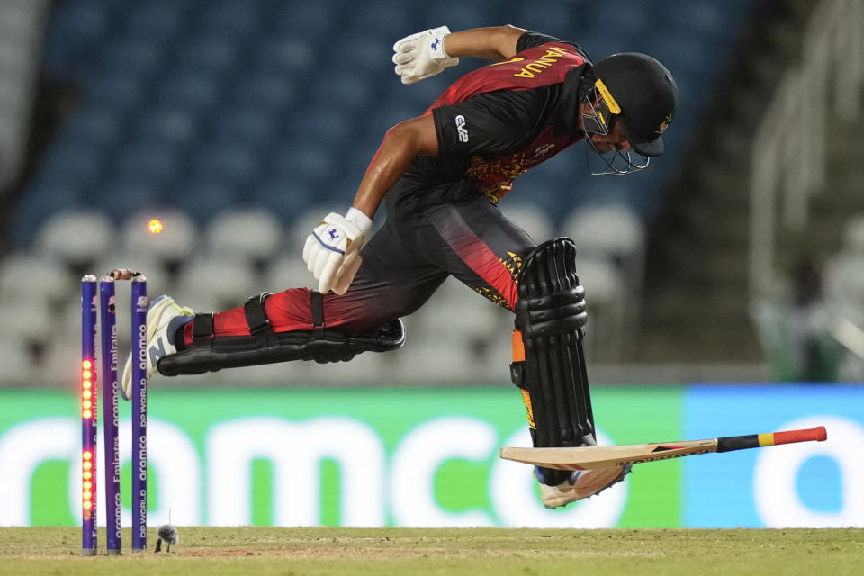Papua New Guinea's Norman Vanua is run out during an ICC Men's T20 World Cup cricket match against Afghanistan at Brian Lara Cricket Academy in Tarouba, Trinidad and Tobago, Thursday, June 13, 2024. (AP Photo/Ramon Espinosa)