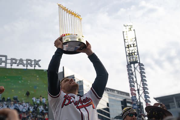 ATLANTA, GA - NOVEMBER 05: Freddie Freeman holds the Commissioner's Trophy as members of the Atlanta Braves celebrate following their World Series Parade at Truist Park on November 5, 2021 in Atlanta, Georgia. The Atlanta Braves won the World Series in six games against the Houston Astros winning their first championship since 1995. (Photo by Megan Varner/Getty Images)