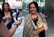 A member of "Mothers of Srebrenica" association talks with the media as she waits for the ruling on the case brought by relatives of the victims of the 1995 Srebrenica massacre, at the Dutch high court in The Hague