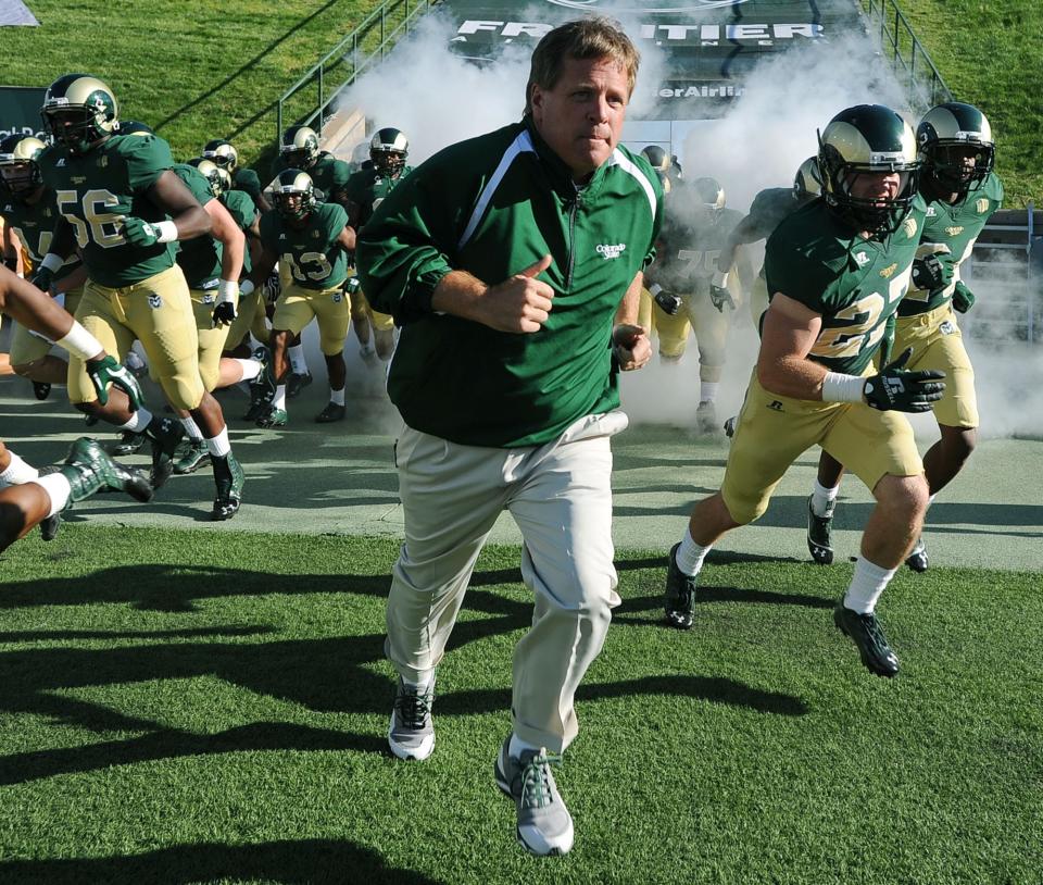 Jim McElwain leads CSU's football team onto the field at Hughes Stadium in his first season as the Rams head coach in 2012.