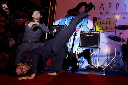 Policemen dance during the launch of the "Happy Zone" program aiming to improve the image of the city in Pattaya, Thailand March 25, 2017. REUTERS/Jorge Silva