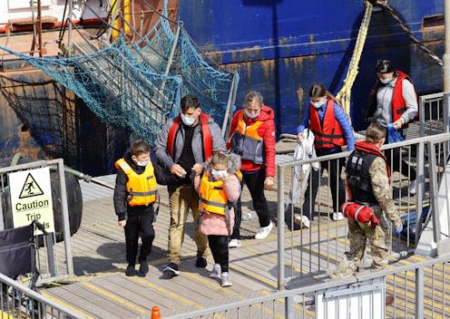 <span class="caption">Asylum seekers are brought ashore after being rescued at sea by Border Force in Dover, Kent, in September 2022. </span> <span class="attribution"><a class="link " href="https://www.shutterstock.com/image-photo/dover-kent-uk-22nd-september-2022-2205152061" rel="nofollow noopener" target="_blank" data-ylk="slk:Sean Aidan Calderbank|Shutterstock;elm:context_link;itc:0;sec:content-canvas">Sean Aidan Calderbank|Shutterstock</a></span>