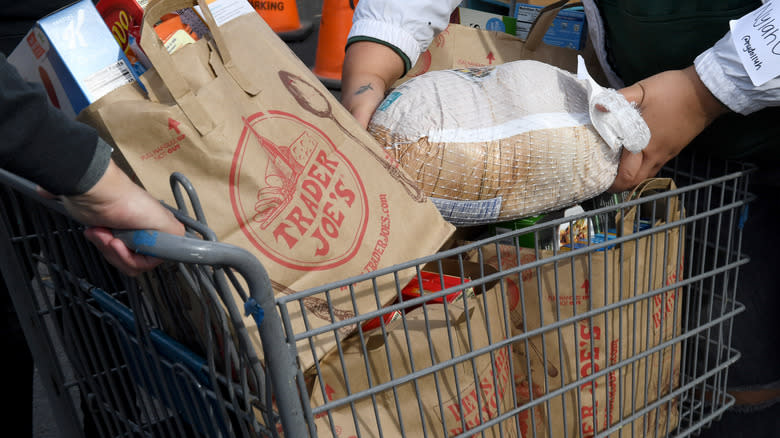 shopping cart with trader joe's bags