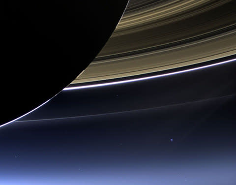 Earth appears as a pale blue dot below Saturn's majestic rings in this stunning image taken by the Cassini space probe - can you spot it? - Credit:  PA