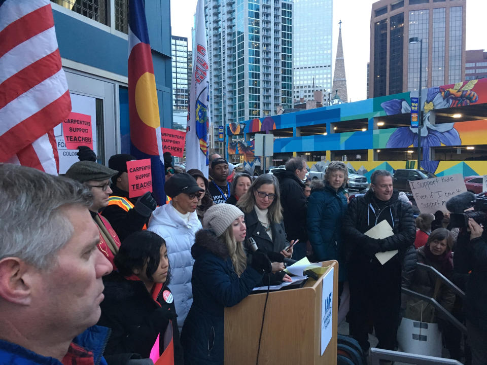 Becca Hendricks, a math teacher at Emily Griffith High School, addresses a crowd of about 200 assembled outside Denver Public School headquarters, Thursday, Jan. 24, 2019, in downtown Denver. Teachers have overwhelmingly voted to strike but their plans to walk off the job have been placed on hold after the district asked the state to intervene. (AP Photo/P. Solomon Banda)