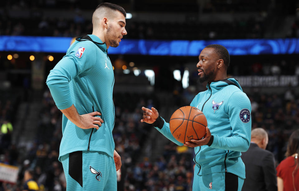 Charlotte Hornets guard Kemba Walker, right, confers with center Willy Hernangomez as they warm up before an NBA basketball game against the Denver Nuggets, Saturday, Jan. 5, 2019, in Denver. (AP Photo/David Zalubowski)