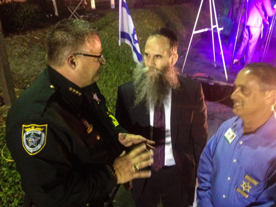 Rabbi Zvi Konikov talks with Brevard County Sheriff Wayne Ivey during a 2015 holiday celebration.