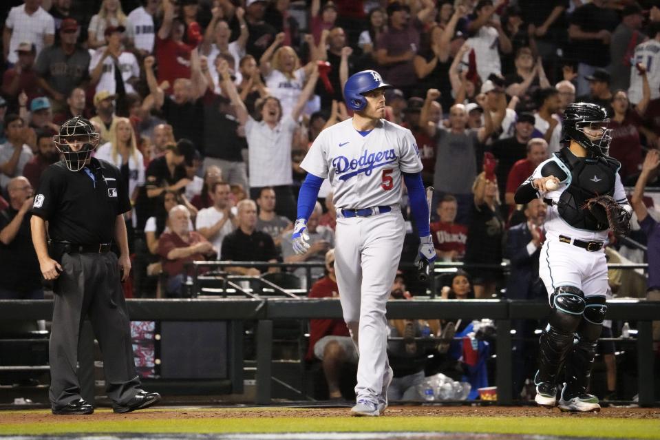 Dodgers' Freddie Freeman walks back to the dugout after striking out against the Diamondbacks in the eighth inning of Game 3.