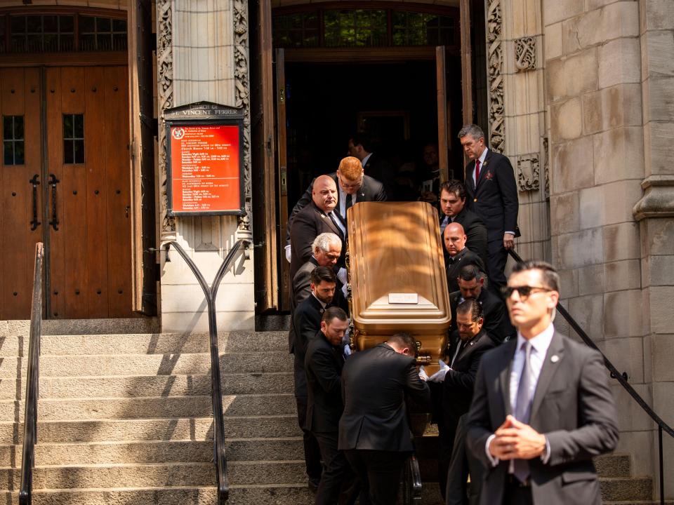 A casket being carried inside to a church.