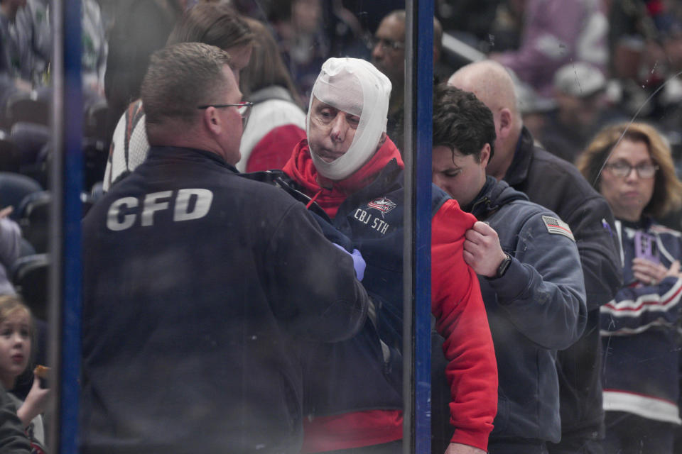 Medical staff attends to a fan who was hit by a puck prior to the first period of an NHL hockey game between the Columbus Blue Jackets and the Ottawa Senators Thursday, March 14, 2024, in Columbus, Ohio. (AP Photo/Jeff Dean)