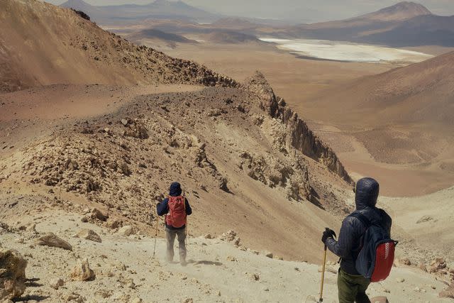 <p>Nick Ballón</p> Descending the slope of Irruputuncu Volcano.