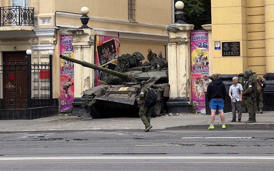 Fighters of Wagner private mercenary group are seen atop of a tank in a street near the headquarters of the Southern Military District in the city of Rostov-on-Don