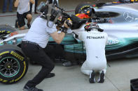 <p>Mercedes driver Lewis Hamilton of Britain touches his car as he celebrates after winning the Japanese Formula One Grand Prix at Suzuka Circuit in Suzuka, central Japan, Sunday, Oct. 8, 2017. (AP Photo/Eugene Hoshiko)</p>