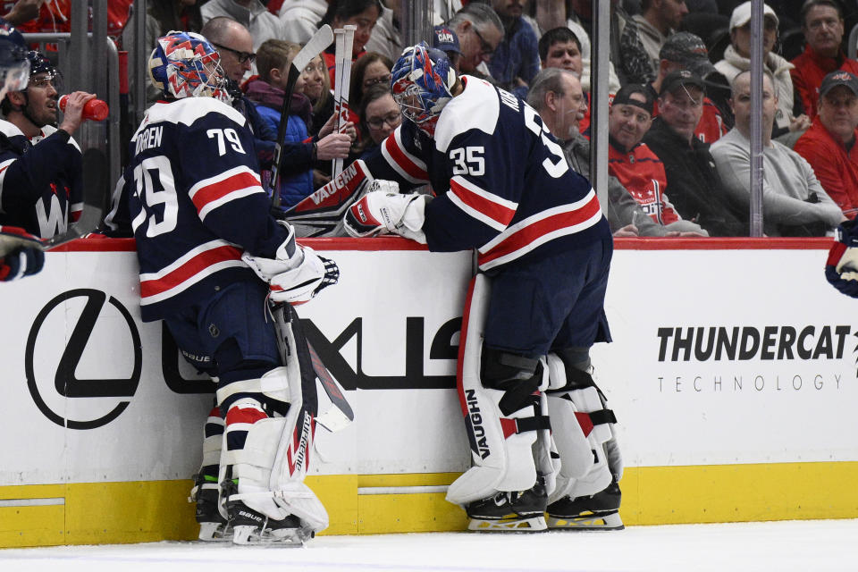 Washington Capitals goaltender Darcy Kuemper (35) replaces goaltender Charlie Lindgren (79) at goal after the Montreal Canadiens scored three goals during the first period of an NHL hockey game, Tuesday, Feb. 6, 2024, in Washington. (AP Photo/Nick Wass)