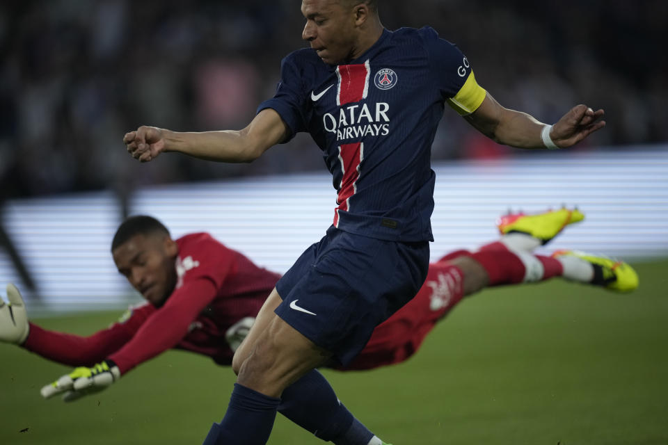 PSG's Kylian Mbappe scores his side's opening goal during the French League One soccer match between Paris Saint-Germain and Toulouse at the Parc des Princes stadium in Paris, Sunday, May 12, 2024. (AP Photo/Christophe Ena)
