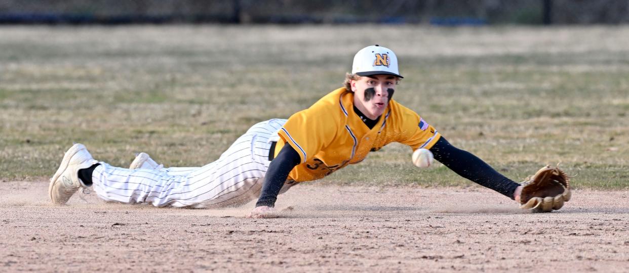 Nauset shortstop Ethan Beer dives for a ball hit by Ty Reed of St. John Paul II.