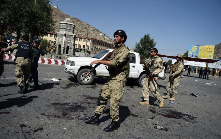 Afghan security personnel arrive after a suicide attack that targeted crowds of minority Shiite Hazaras during a demonstration in Kabul on July 23, 2016