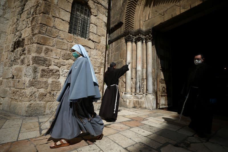 A Catholic nun wearing a mask leaves the Church of the Holy Sepulchre after an Easter Sunday service amid the coronavirus disease (COVID-19) outbreak, in Jerusalem's Old City