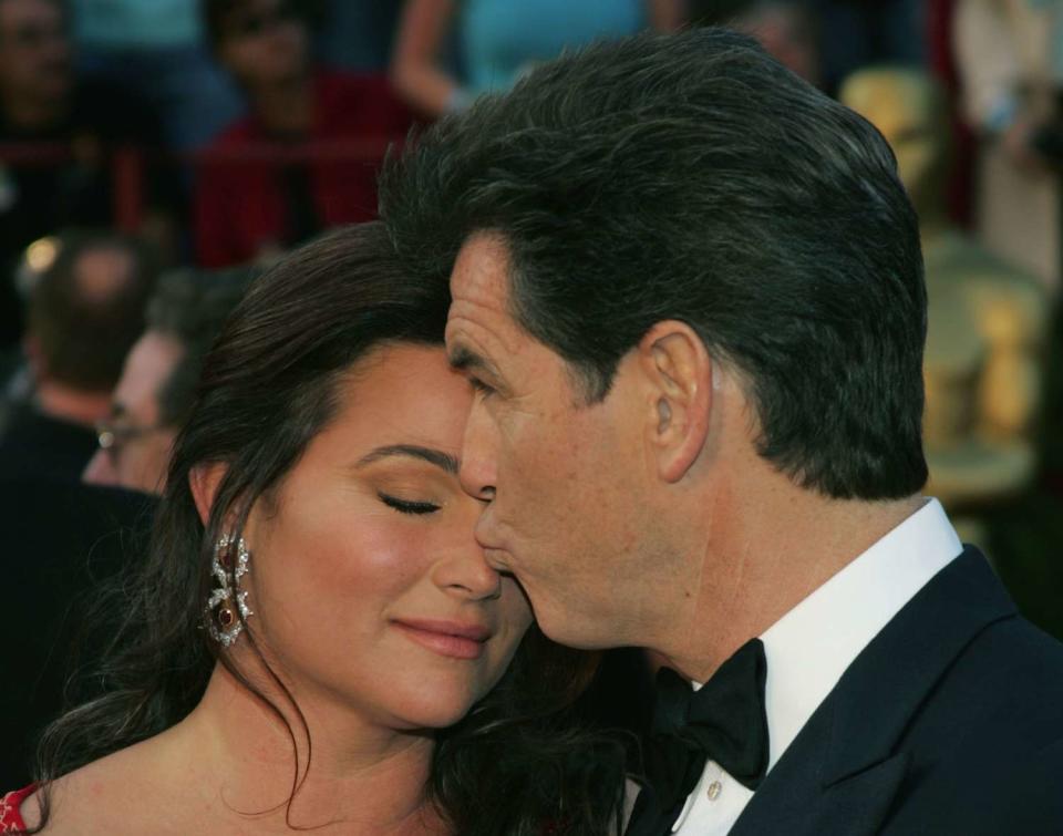 Pierce Brosnan (R) and his wife Keely Shaye Smith arrive at the 77th Annual Academy Awards at the Kodak Theater on February 27, 2005 in Hollywood, California