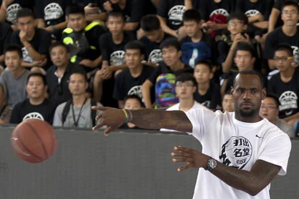 LeBron James throws a basketball during a Nike-sponsored event in Beijing, China,