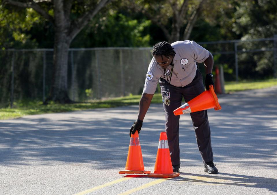 Tony Sears, an Indian River schools' trainer, sets out cones in a driving course at the bus training compound, Monday, Oct. 16, 2023, in Indian River County. "We're looking for some people who are dependable – someone who wants a new and better career," Sears said.