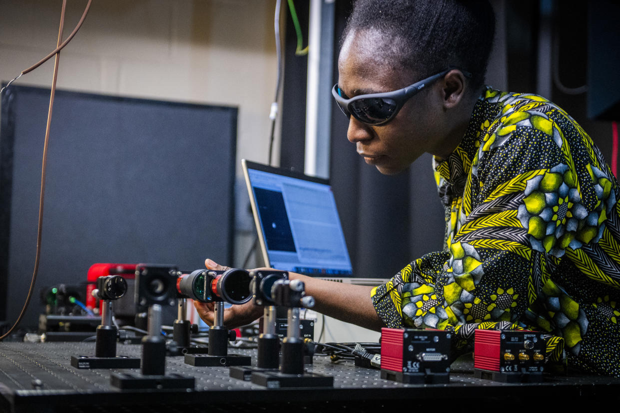 Dr Elizabeth Eso aligning an optical system to experimentally demonstrate a time-bin quantum key distribution system 