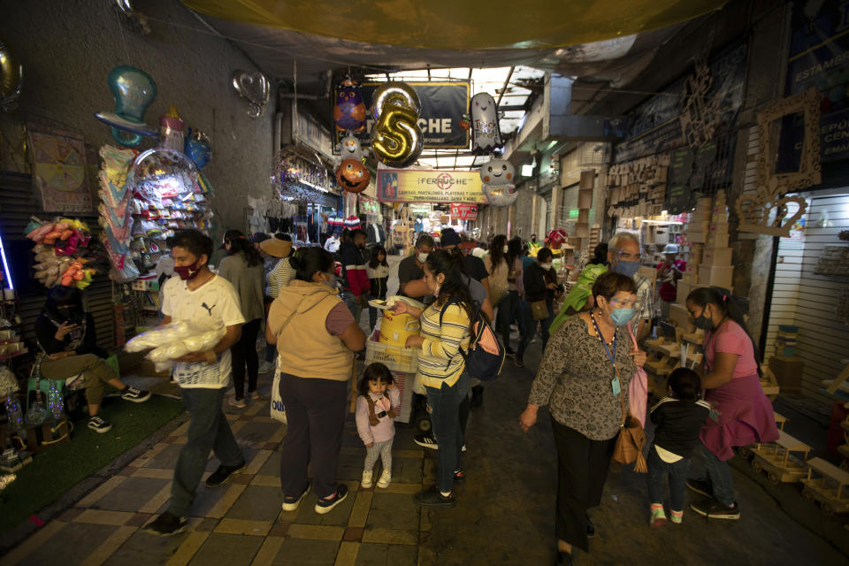 People shop at a market in downtown Mexico City, Friday, Oct. 30, 2020. Prior to the coronavirus pandemic, Mexico’s economy was in recession, and that only deepened with the economic shutdown provoked by measures aimed at slowing the spread of COVID-19 during the second quarter. (AP Photo/Fernando Llano)