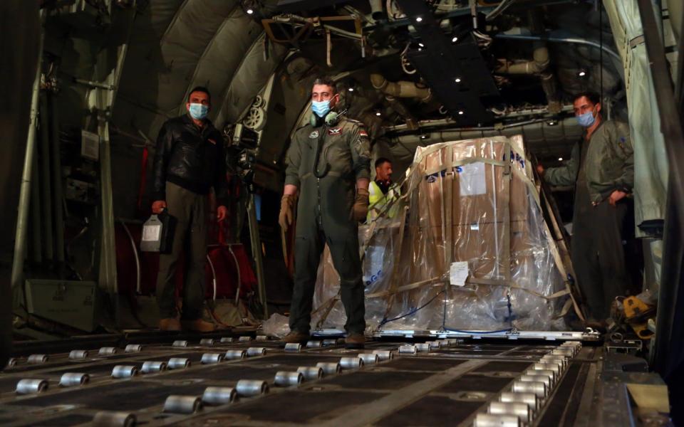 Officials unload China's Sinopharm vaccine donated to Iraq after the plane arrived at Baghdad International Airport - Murtadha Al-Sudani/Anadolu Agency via Getty Images