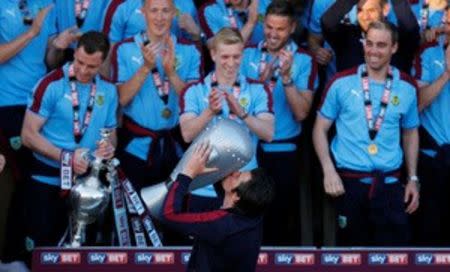 Britain Soccer Football - Burnley - Sky Bet Football League Championship Winners Parade - Burnley - 9/5/16 Burnley's Joey Barton celebrates with a bloew up trophy after winning the Sky Bet Football League Action Images via Reuters / Jason Cairnduff