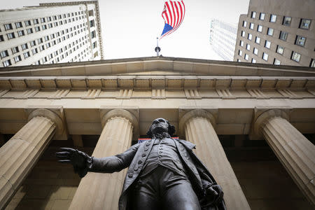 The U.S. flag flies over a statue of George Washington outside Federal Hall National Memorial, as the partial U.S. government shutdown continues in New York, U.S., January 7, 2019. REUTERS/Brendan McDermid