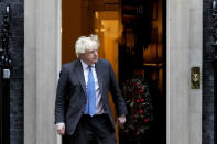 Britain's Prime Minister Boris Johnson steps out of 10 Downing Street to welcome the Sultan of Oman, Haitham Bin Tarik Al Said, in London, Thursday, Dec. 16, 2021. (AP Photo/Frank Augstein)