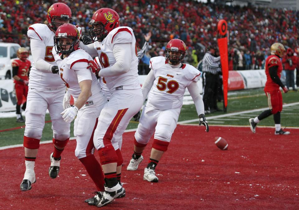 Calgary Dinos Jake Harty (6) celebrates his touchdown on the Laval Rouge et Or with teammates Braden Schram (L), Sean McEwen and Ryan Preuter (59) during the Vanier Cup University Championship football game in Quebec City, Quebec, November 23, 2013. REUTERS/Mathieu Belanger (CANADA - Tags: SPORT FOOTBALL)