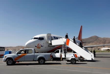 Crew members of a private airline depart from a plane at the Kabul International Airport in Kabul, Afghanistan, 26 June 2018. REUTERS/Omar Sobhani/Files