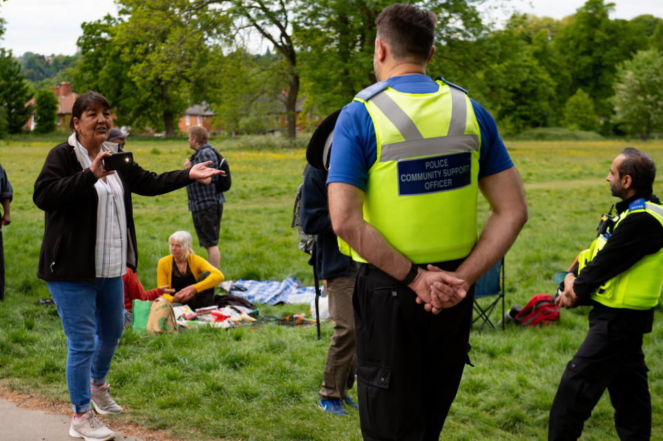 Police monitor a gathering of people at Highbury Park in Birmingham, after the introduction of measures to bring the country out of lockdown.