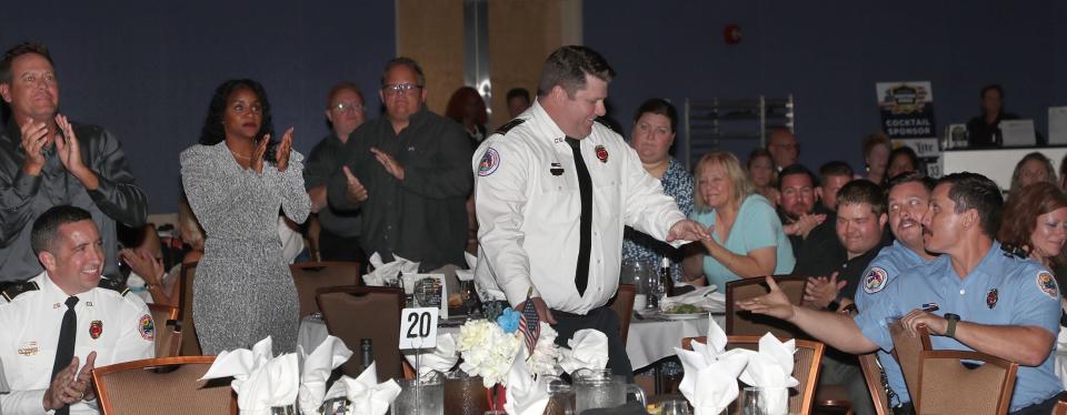 Daytona Beach Fire Department Battalion Chief Steven Taft makes his way to the stage after being named "First Responder of the Year" at The Daytona Beach News-Journal's fourth annual Hometown Heroes awards dinner at the Ocean Center in Daytona Beach on Friday, Oct. 28, 2022.