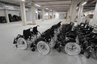 New wheelchairs sit in the empty Isabel Zendal new hospital during the official opening in Madrid, Spain, Tuesday, Dec. 1, 2020. Authorities in Madrid are holding a ceremony to open part of a 1,000-bed hospital for emergencies that critics say is no more than a vanity project, a building with beds not ready to receive patients and unnecessary now that contagion and hospitalizations are waning. Spain has officially logged 1.6 million infections and over 45,000 deaths confirmed for COVID-19 since the beginning of the year. (AP Photo/Paul White)