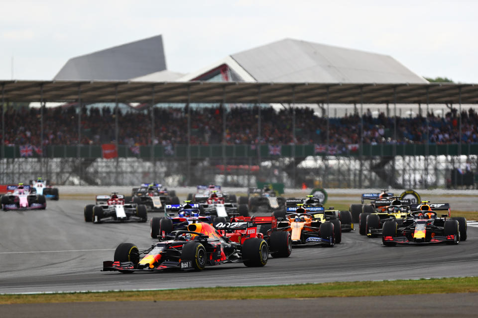 NORTHAMPTON, ENGLAND - JULY 14: Max Verstappen of the Netherlands driving the (33) Aston Martin Red Bull Racing RB15 leads Pierre Gasly of France driving the (10) Aston Martin Red Bull Racing RB15 on lap one during the F1 Grand Prix of Great Britain at Silverstone on July 14, 2019 in Northampton, England. (Photo by Dan Istitene/Getty Images)