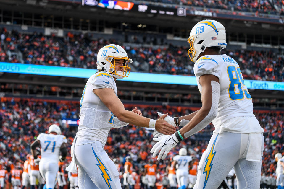 DENVER, CO - JANUARY 8: Los Angeles Chargers quarterback Justin Herbert (10) celebrates with Los Angeles Chargers tight end Donald Parham Jr. (89) after a second quarter touchdown catch during a game between the Los Angeles Chargers and the Denver Broncos at Empower Field at Mile High on January 8, 2023 in Denver, Colorado. (Photo by Dustin Bradford/Icon Sportswire via Getty Images)