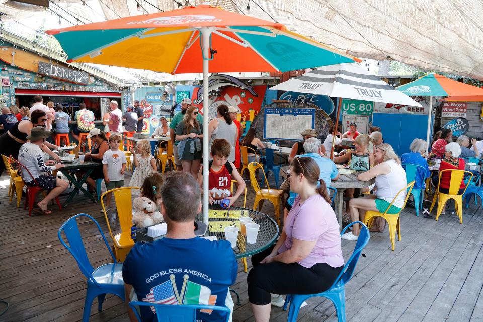 Guests gather on the deck at Huc-A-Poo's on Tybee Island.