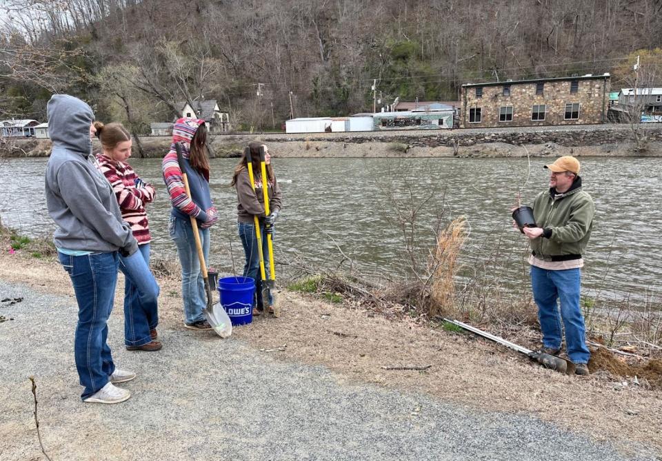 Madison High teacher Chad Ayers, right, instructs his horticulture students on livestaking March 8.