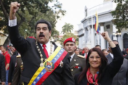 Venezuela's President Nicolas Maduro (L) and his wife Cilia Flores gesture to supporters as he arrives at the National Assembly to deliver his annual State of the Nation address in Caracas January 21, 2015. REUTERS/Carlos Garcia Rawlins